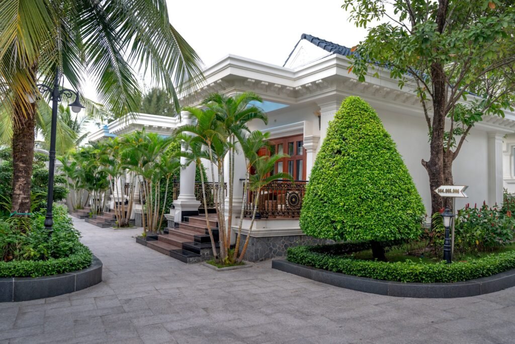 Elegant resort entrance surrounded by lush tropical greenery and manicured gardens.