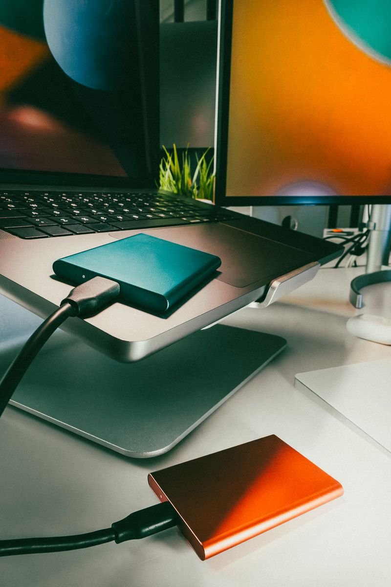 Stylish home office setup featuring laptop and external drives for data storage and backup.