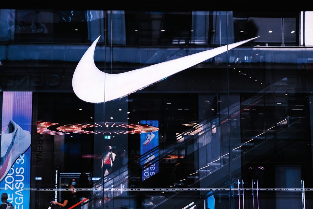 Stylish architectural facade featuring illuminated signage and glass panels, capturing a modern vibe.